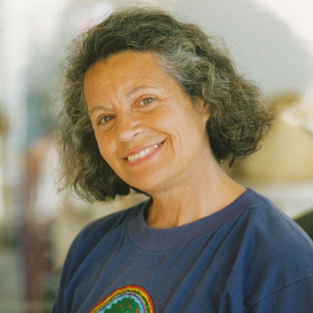 Portrait of Emilia Hazelip, smiling, in a blue T-shirt.